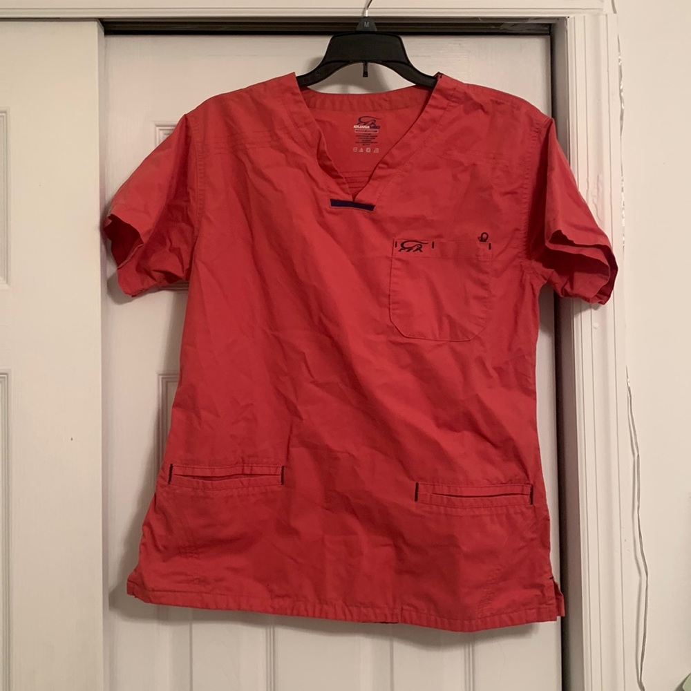 Pink scrub top brand is iguana med size small